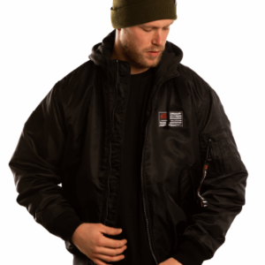 man with beanie and a black bomberjacket from great injuries